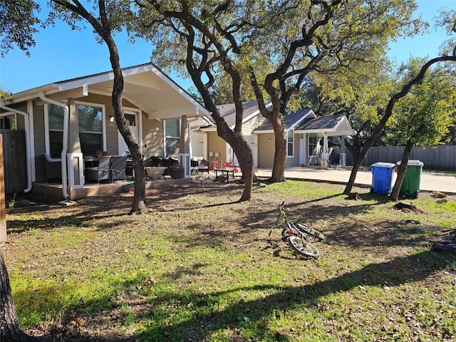 view of yard featuring driveway, a patio area, and fence