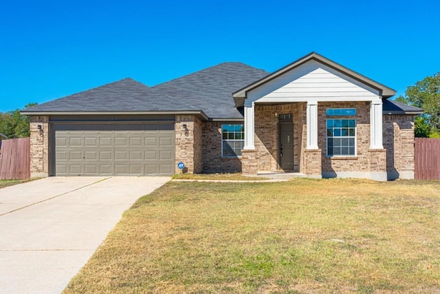 view of front of property featuring a garage and a front lawn