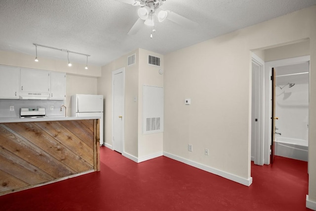 4205 Speedway Ave Unit 204, Austin, TX 78751 - unfurnished living room featuring a textured ceiling, a ceiling fan, rail lighting, and baseboards