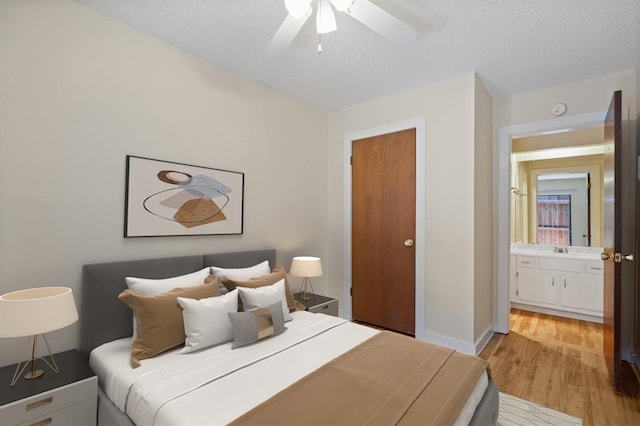 bedroom with sink, a textured ceiling, ceiling fan, and light hardwood / wood-style flooring