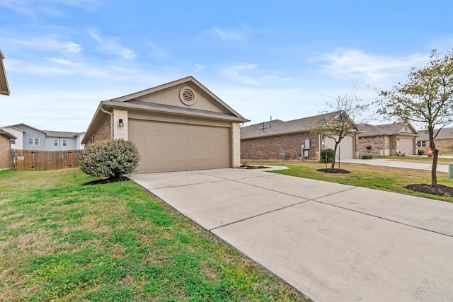 view of front of property featuring a front lawn, concrete driveway, fence, and an attached garage