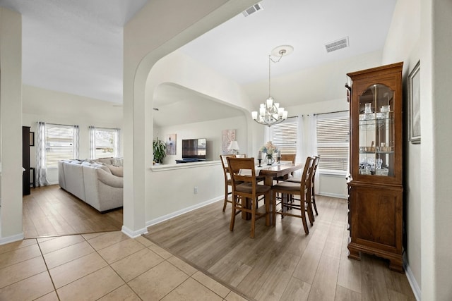 1017 Matheson Dr, Leander, TX 78641 - dining room with a chandelier, wood finished floors, baseboards, and vaulted ceiling