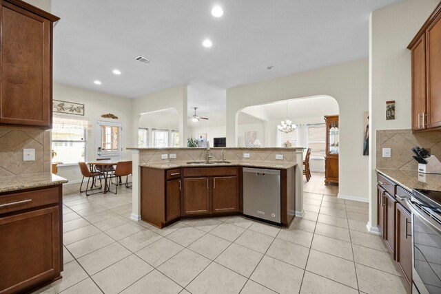 1017 Matheson Dr, Leander, TX 78641 - kitchen featuring stainless steel appliances, arched walkways, tasteful backsplash, a chandelier, and ceiling fan
