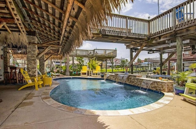 view of pool featuring a hot tub and a patio area