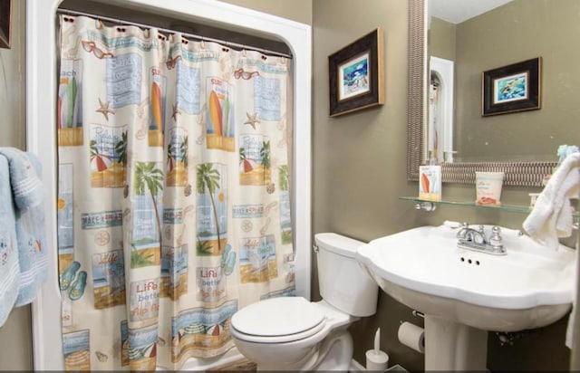 bathroom with a shower with curtain and toilet