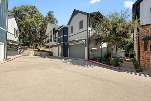 exterior space featuring a garage and a balcony