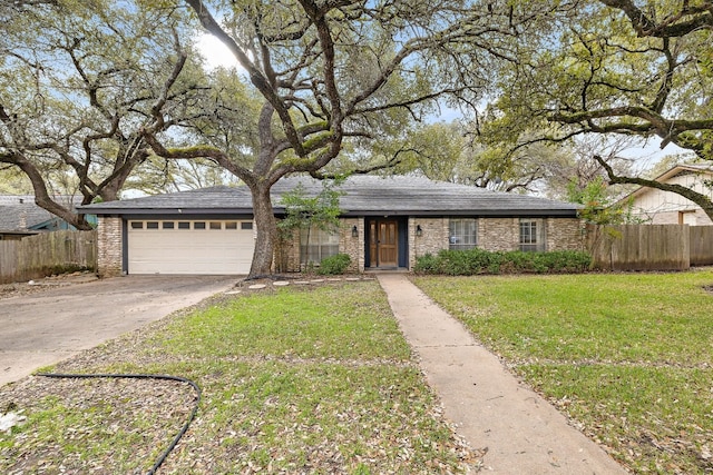 ranch-style home with a garage and a front yard