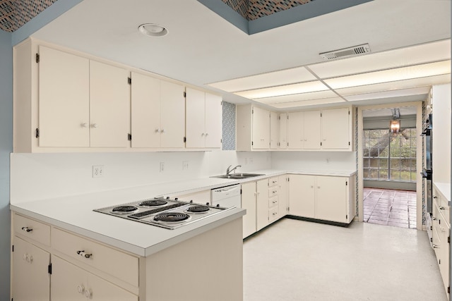 kitchen featuring white cabinetry, sink, and white stovetop