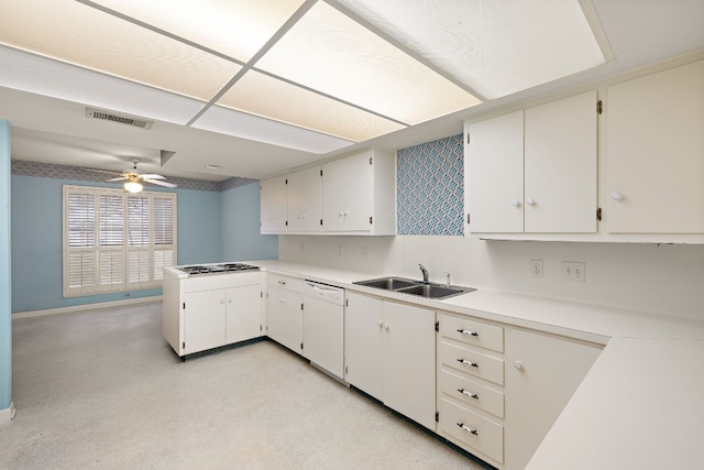 kitchen featuring white cabinetry, stainless steel gas cooktop, white dishwasher, and sink