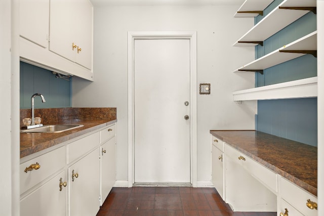 kitchen featuring white cabinetry and sink