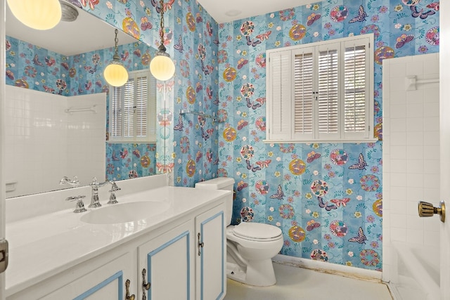 full bathroom featuring tiled shower / bath combo, vanity, and toilet