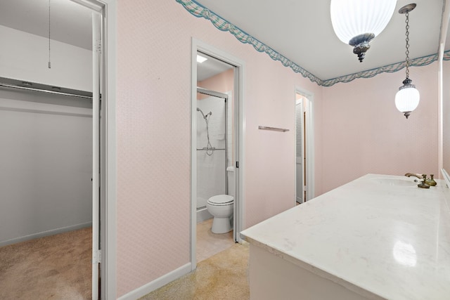 bathroom with walk in shower, vanity, and toilet