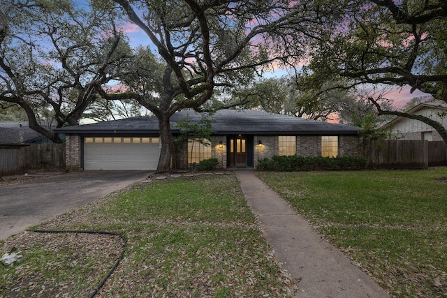 view of front of house with a yard and a garage