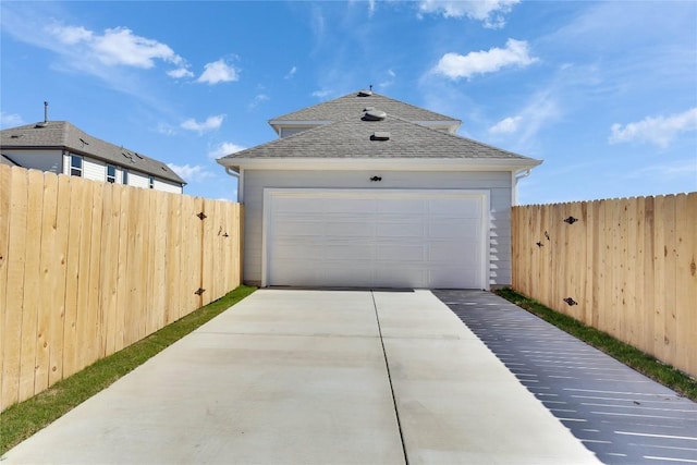 detached garage featuring fence