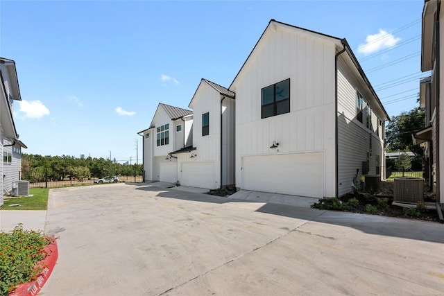 2707 Dulce Ln Unit 7, Austin, TX 78704 - view of front of property featuring an attached garage, concrete driveway, and board and batten siding