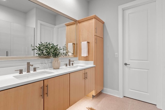 2707 Dulce Ln Unit 12, Austin, TX 78704 - bathroom featuring double vanity and baseboards