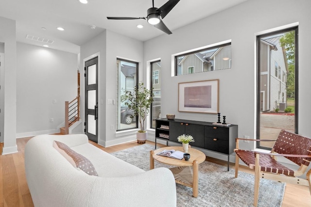 2707 Dulce Ln Unit 12, Austin, TX 78704 - living room with stairway, light wood-style flooring, recessed lighting, baseboards, and ceiling fan