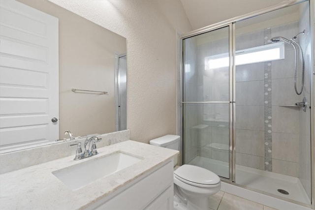 bathroom featuring a shower with door, vanity, and toilet