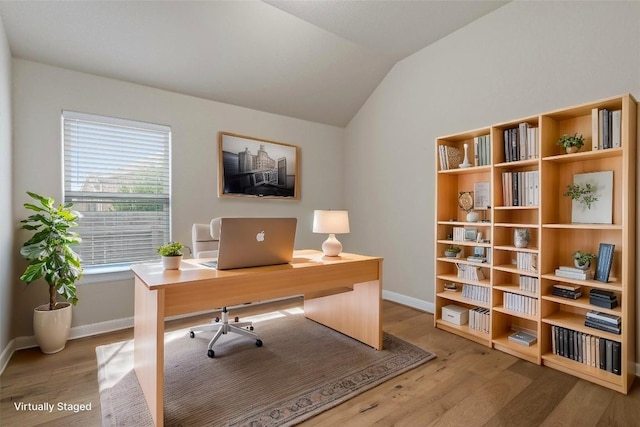 office space featuring wood-type flooring and vaulted ceiling