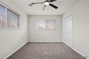 carpeted empty room featuring ceiling fan