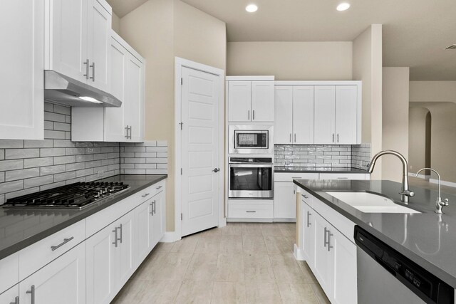 kitchen featuring white cabinetry, sink, backsplash, and stainless steel appliances