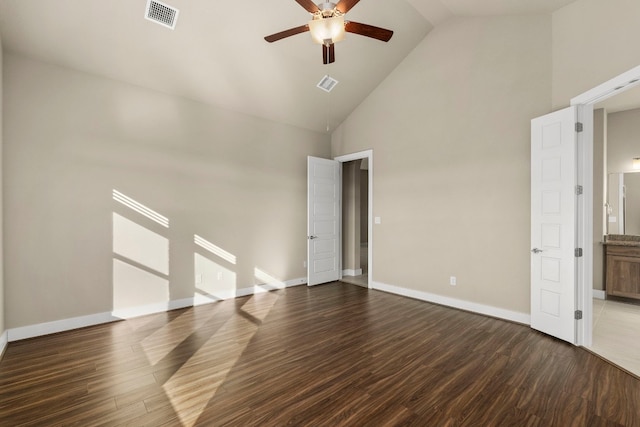 unfurnished bedroom featuring dark wood-type flooring, high vaulted ceiling, and ceiling fan