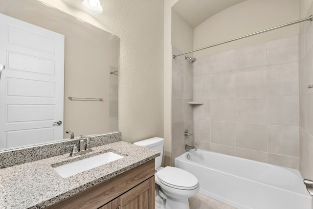 full bathroom with vanity, toilet, and tiled shower / bath combo