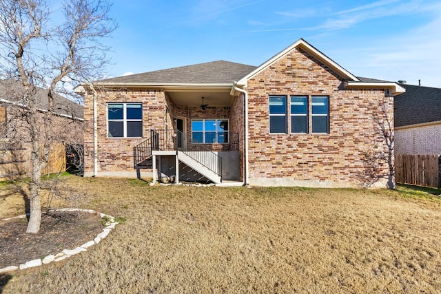 rear view of property with a yard and ceiling fan