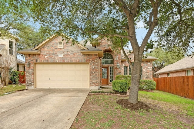 10104 Hibiscus Cv, Austin, TX 78739 - traditional home featuring brick siding, concrete driveway, and an attached garage