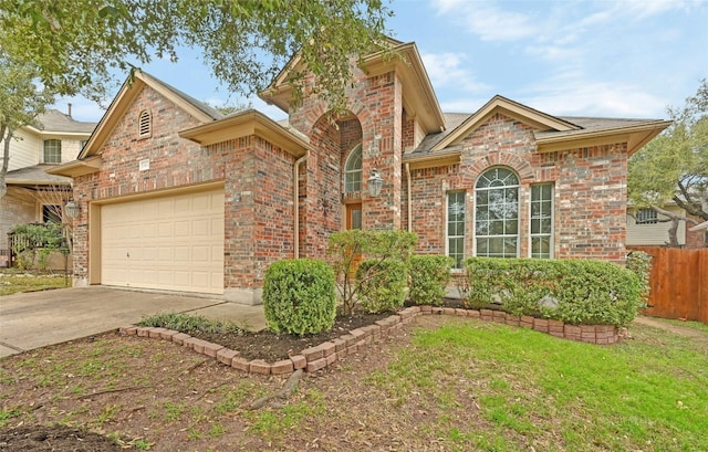 10104 Hibiscus Cv, Austin, TX 78739 - traditional-style house with concrete driveway, brick siding, and a garage