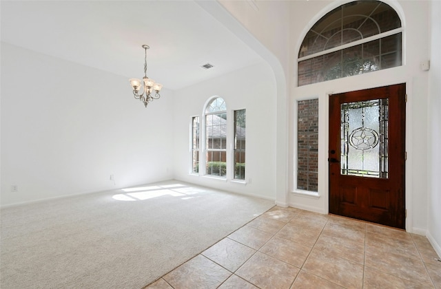 10104 Hibiscus Cv, Austin, TX 78739 - foyer with a chandelier, plenty of natural light, light carpet, and baseboards