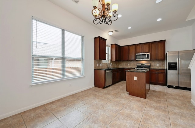10104 Hibiscus Cv, Austin, TX 78739 - kitchen with appliances with stainless steel finishes, backsplash, a chandelier, light tile patterned floors, and recessed lighting