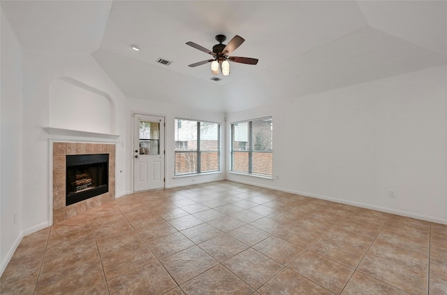 10104 Hibiscus Cv, Austin, TX 78739 - unfurnished living room with a ceiling fan, a tiled fireplace, tile patterned floors, and vaulted ceiling