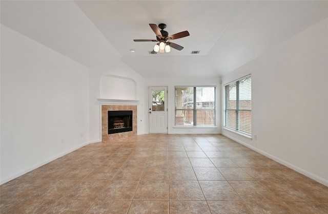 10104 Hibiscus Cv, Austin, TX 78739 - unfurnished living room featuring light tile patterned floors, a ceiling fan, a fireplace, vaulted ceiling, and baseboards