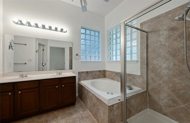 10104 Hibiscus Cv, Austin, TX 78739 - full bath featuring a stall shower, a bath, double vanity, and tile patterned floors