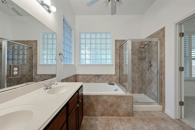 10104 Hibiscus Cv, Austin, TX 78739 - full bathroom with ceiling fan, a bath, a shower stall, and tile patterned flooring