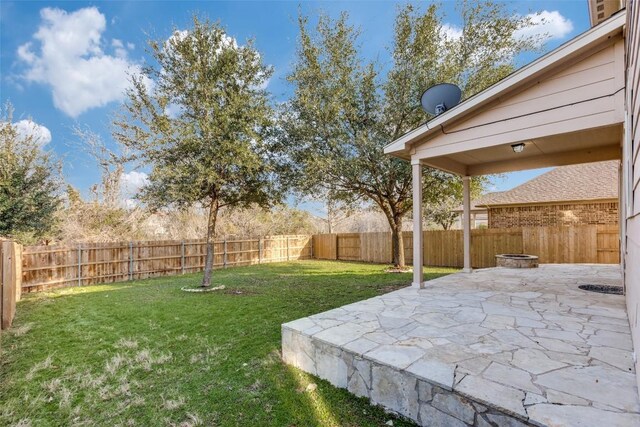 view of yard featuring a patio area, an outdoor fire pit, and a fenced backyard