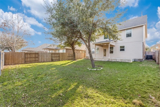 exterior space featuring a yard, central AC unit, and a fenced backyard