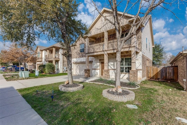 view of front of property featuring an attached garage, a balcony, driveway, and brick siding