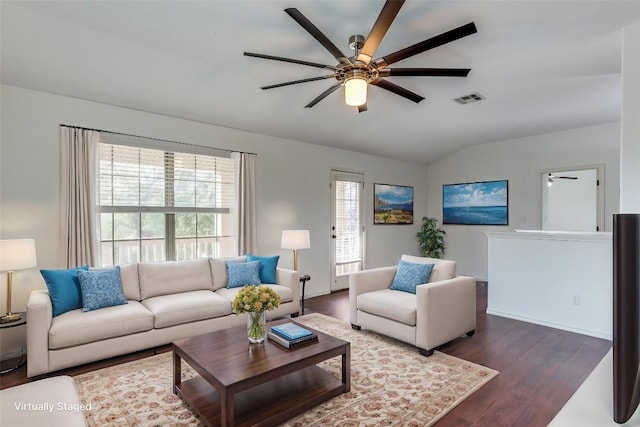 living area with visible vents, a ceiling fan, wood finished floors, and vaulted ceiling
