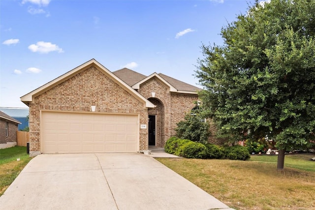 view of front of house with a garage and a front yard