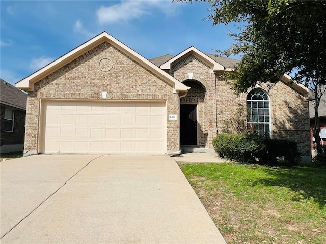 view of front of home featuring a garage and a front lawn