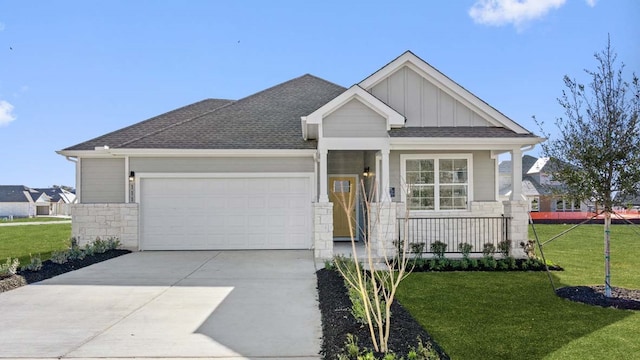 craftsman-style home featuring a porch, a garage, and a front yard