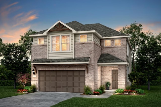 view of front of property featuring a yard and a garage