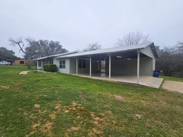 rear view of house with a yard and a patio area