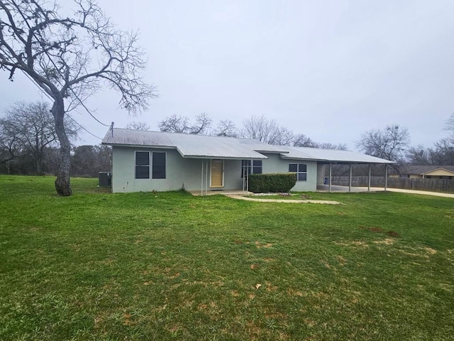 ranch-style home featuring a carport and a front yard