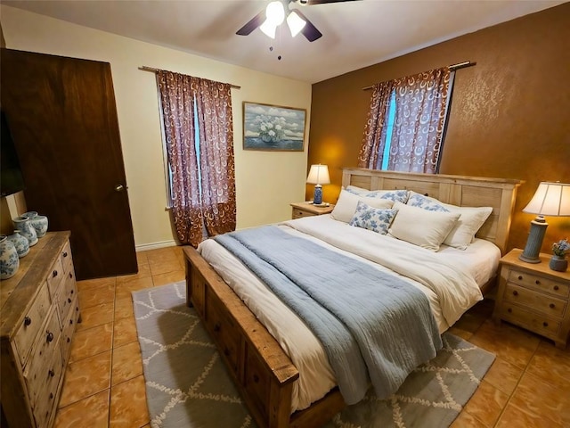 tiled bedroom featuring ceiling fan