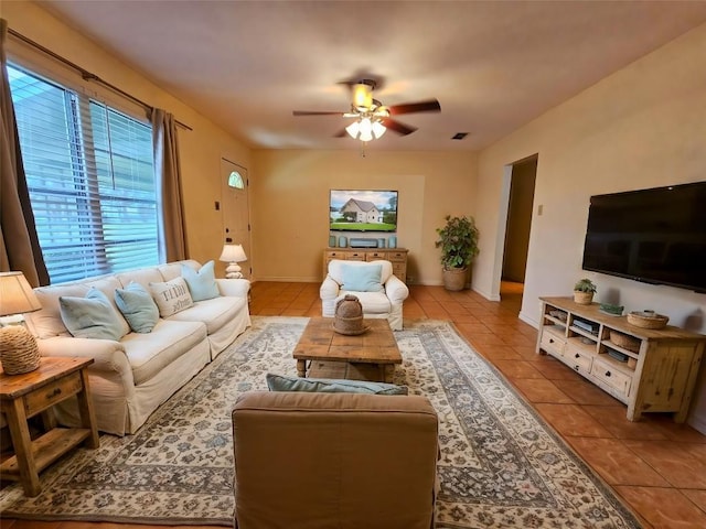 tiled living room with ceiling fan