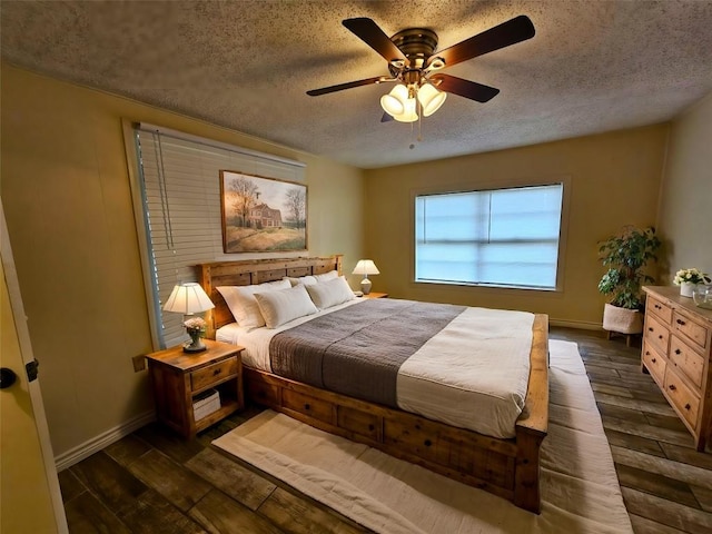 bedroom featuring ceiling fan, dark hardwood / wood-style flooring, and a textured ceiling