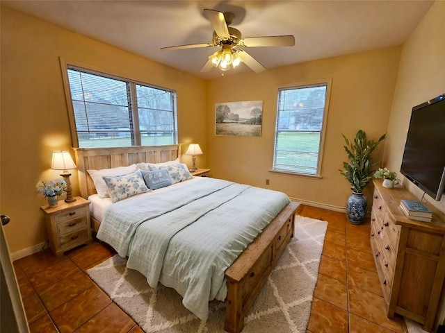 tiled bedroom with multiple windows and ceiling fan